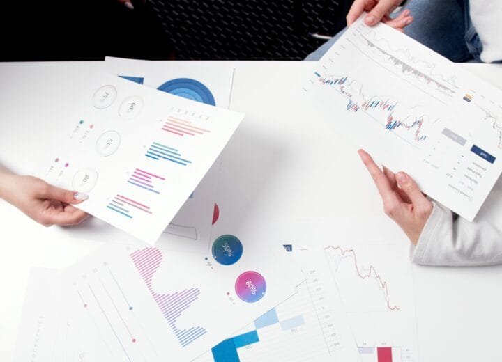 Image of consultants reviewing business charts and graphs during a meeting