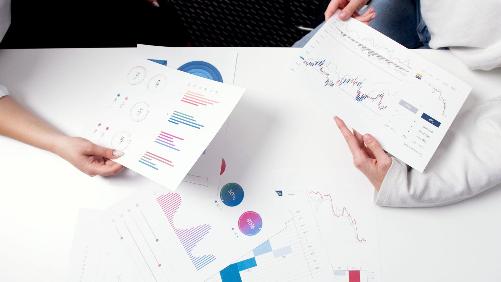 Image of consultants reviewing business charts and graphs during a meeting