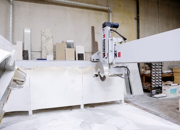 High-tech machine in a factory cutting granite slabs. Industrial setting