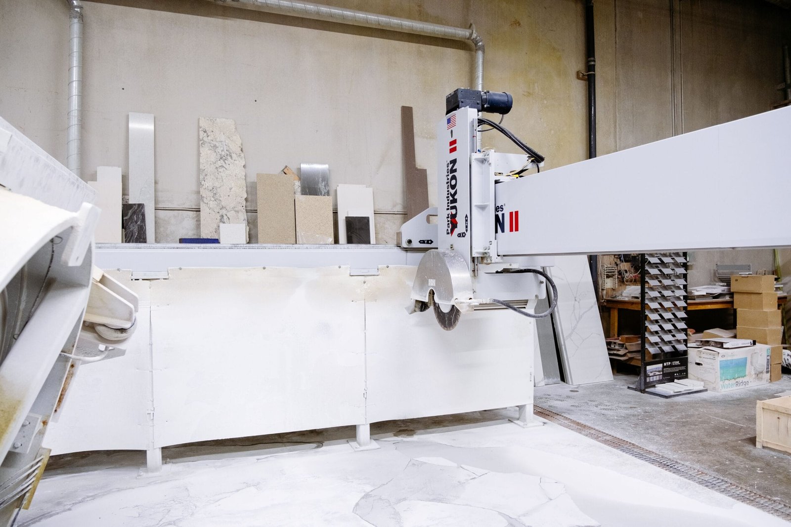 High-tech machine in a factory cutting granite slabs. Industrial setting