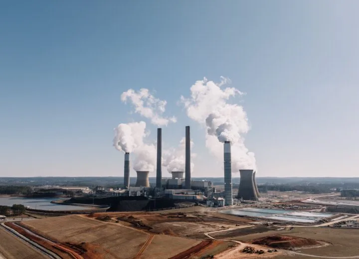Aerial view of a power plant emitting smoke