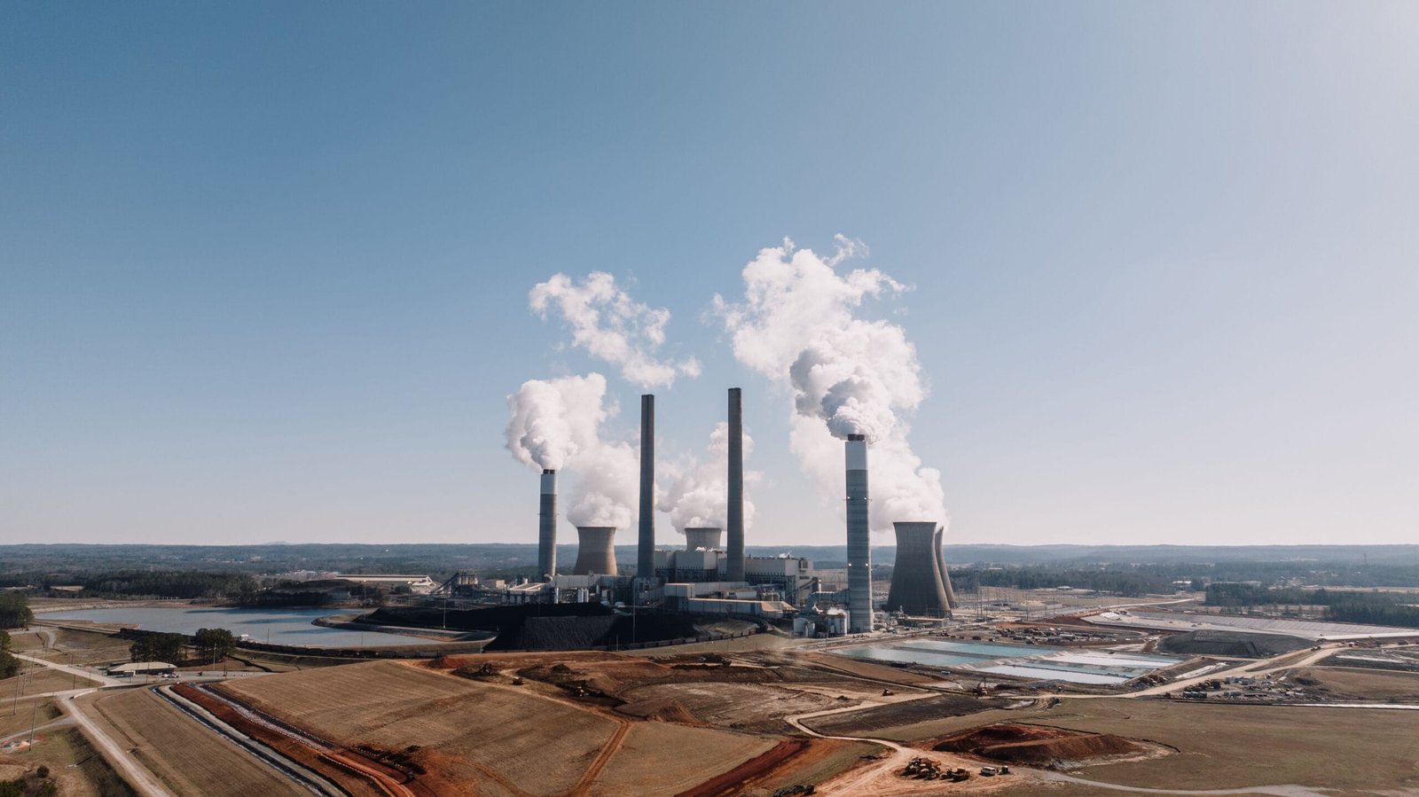 Aerial view of a power plant emitting smoke