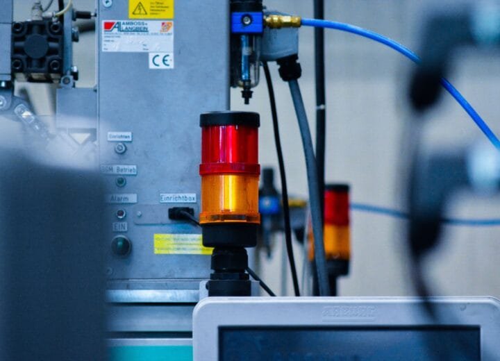 Detailed view of automated machinery with warning signals in an industrial setting