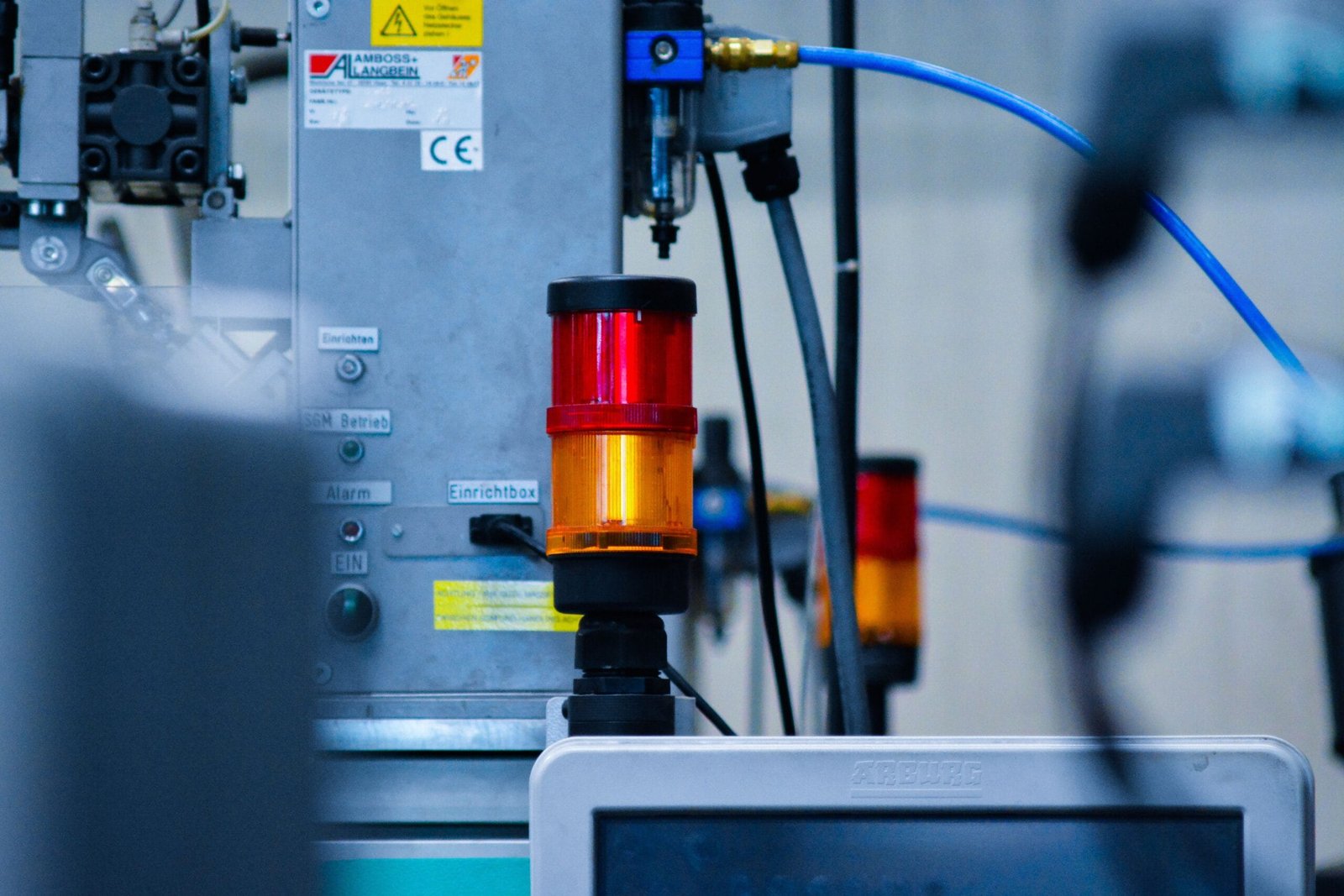 Detailed view of automated machinery with warning signals in an industrial setting