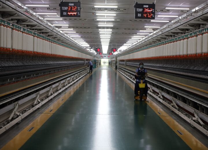Textile factory with spinning machinery and workers