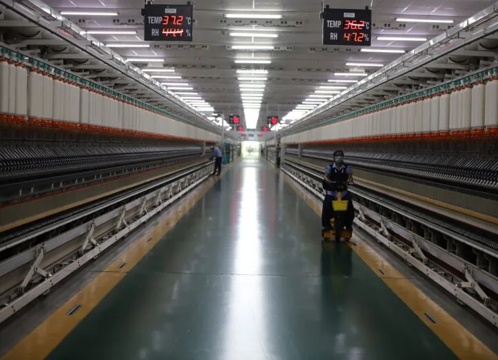 Textile factory with spinning machinery and workers