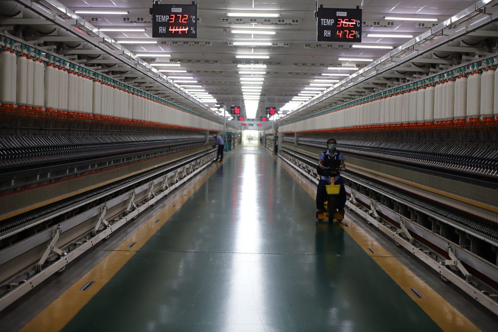 Textile factory with spinning machinery and workers