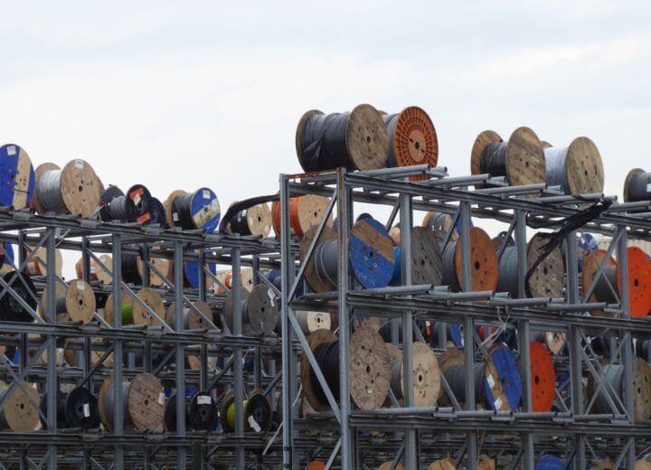 Colorful industrial cable reels stacked outdoors