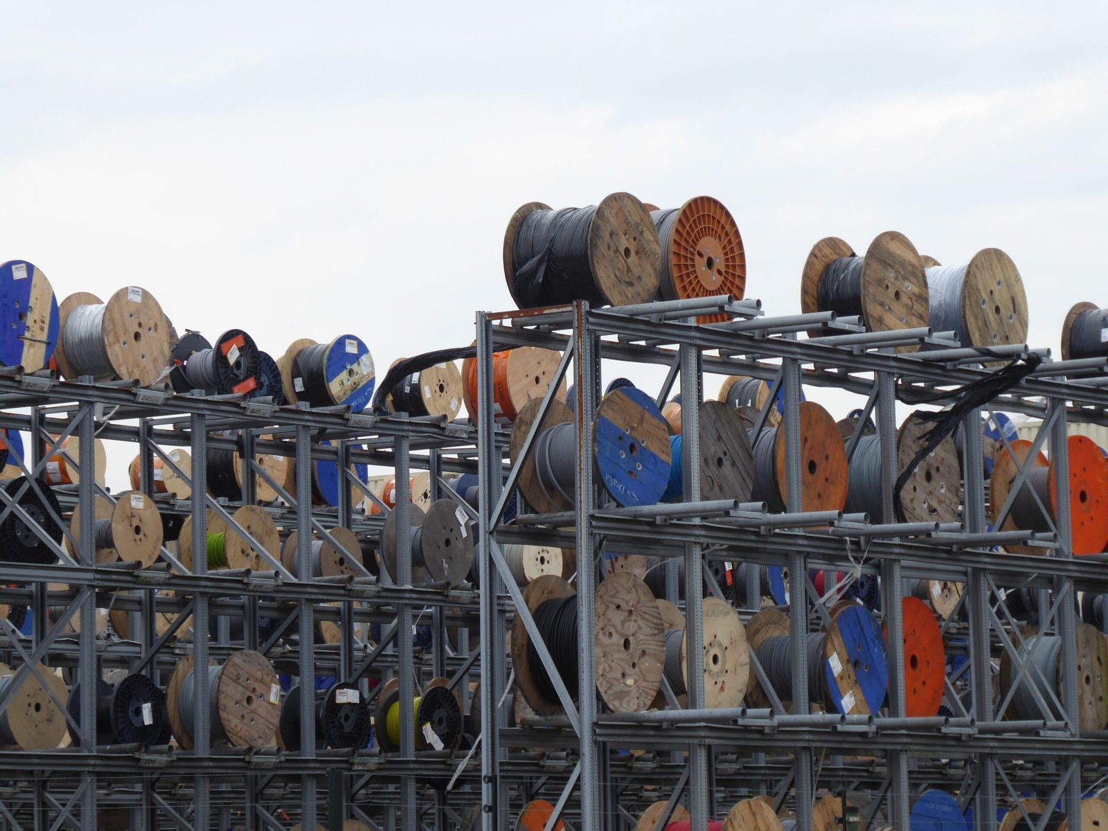 Colorful industrial cable reels stacked outdoors
