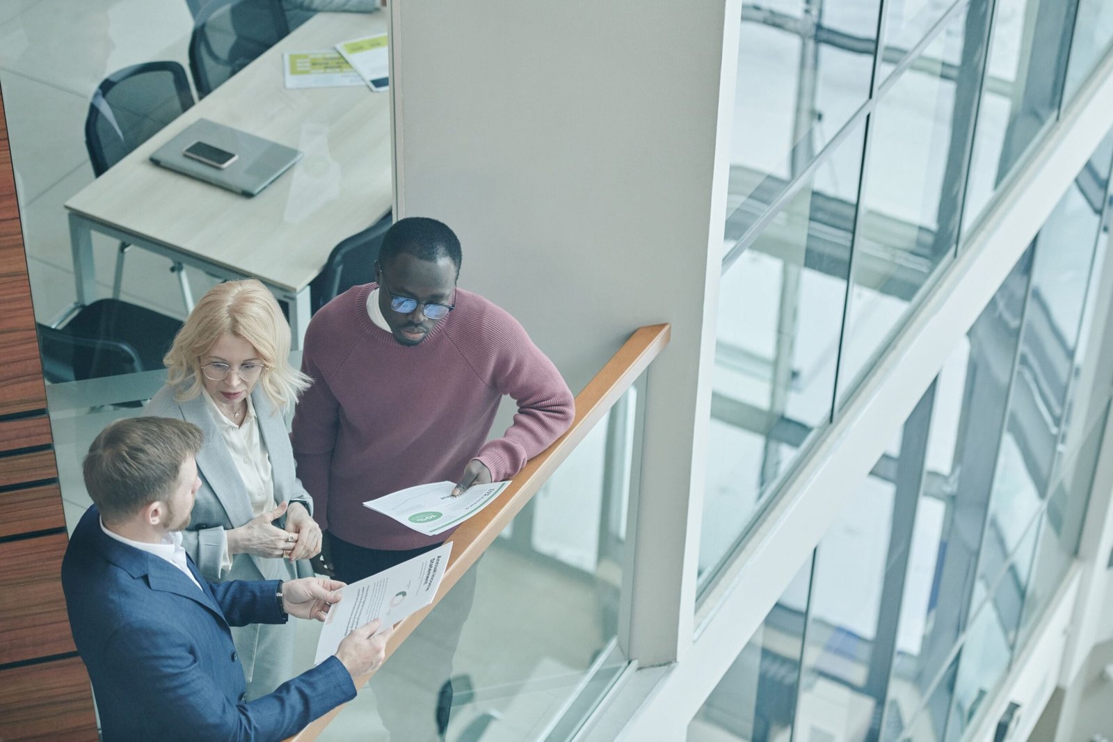 High angle view of diverse colleagues collaborating in a modern office setting.