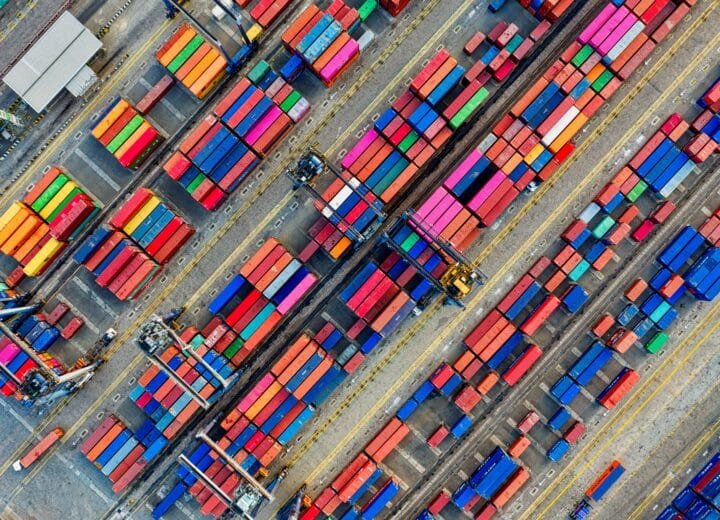Aerial view of vibrant shipping containers at a busy port, showcasing global trade.