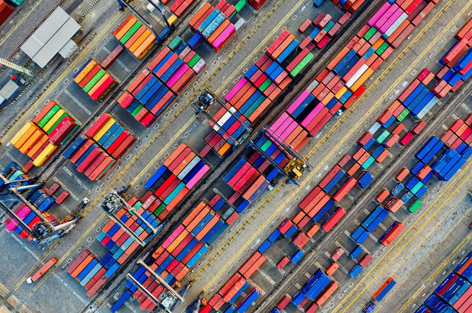 Aerial view of vibrant shipping containers at a busy port, showcasing global trade.